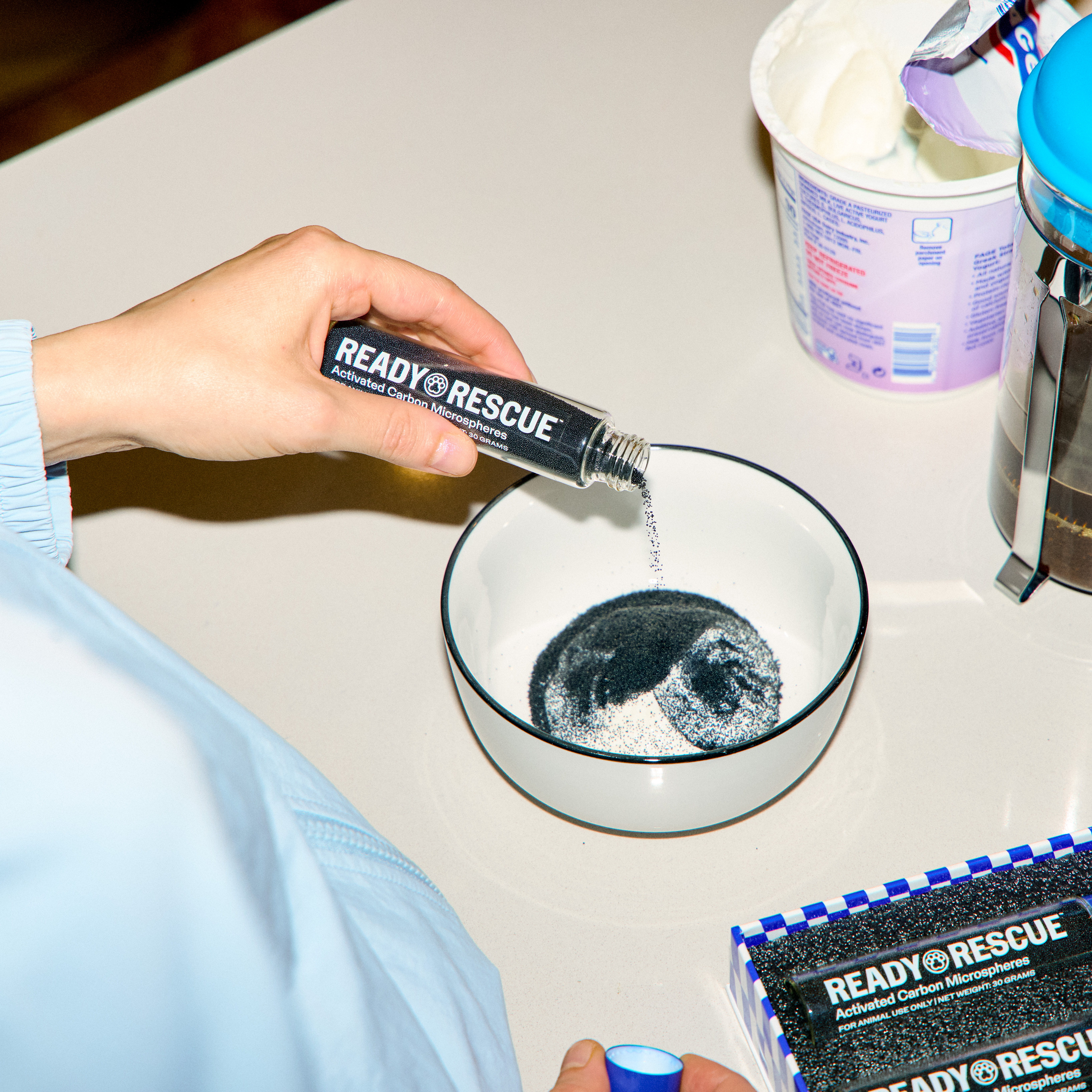 a hand is pouring ReadyRescue product into a bowl